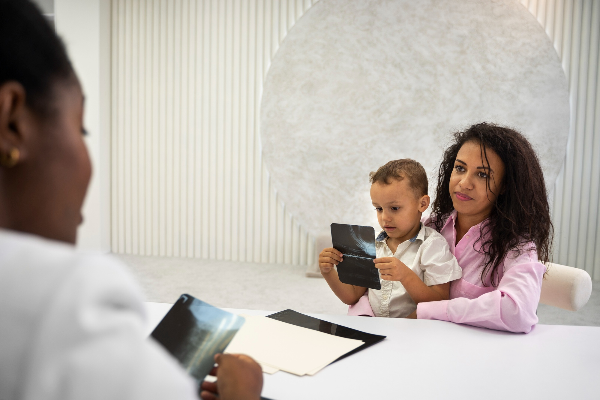 Healthcare professional reviewing a child's medical information with the family
